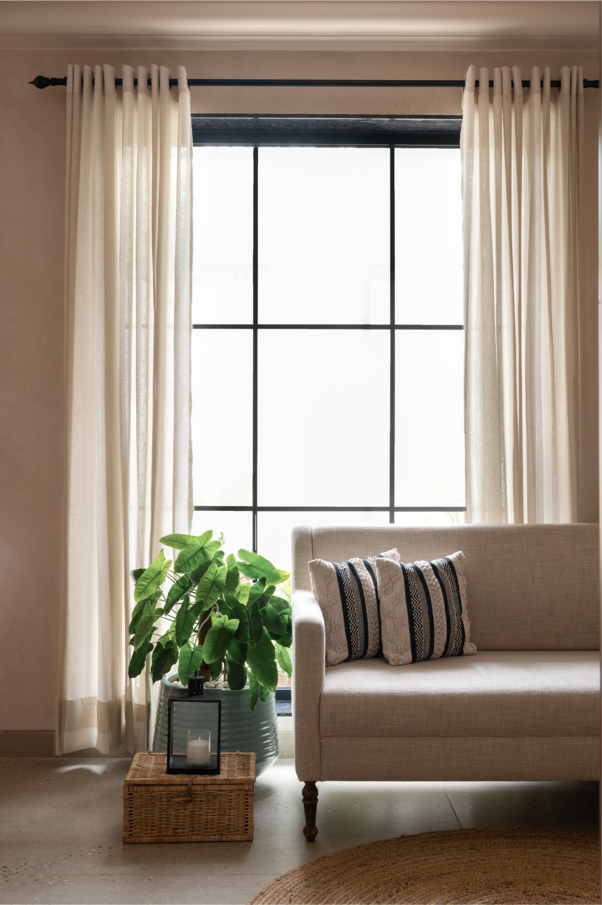 Waiting lounge with linen sofa and tall window