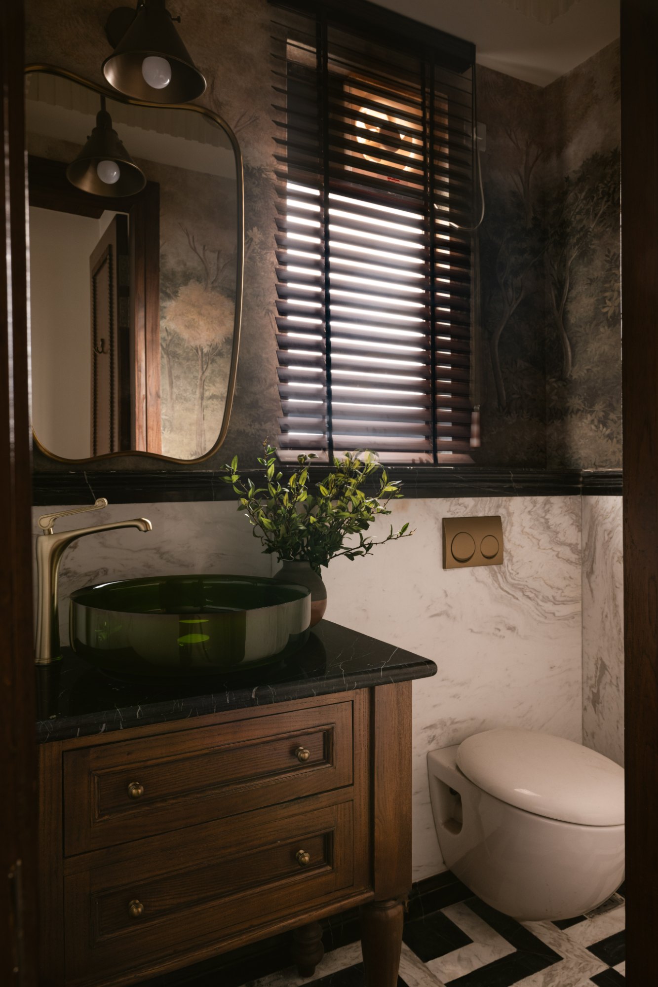 Powder room with a green glass basin, forest mural and checkerboard marble floor