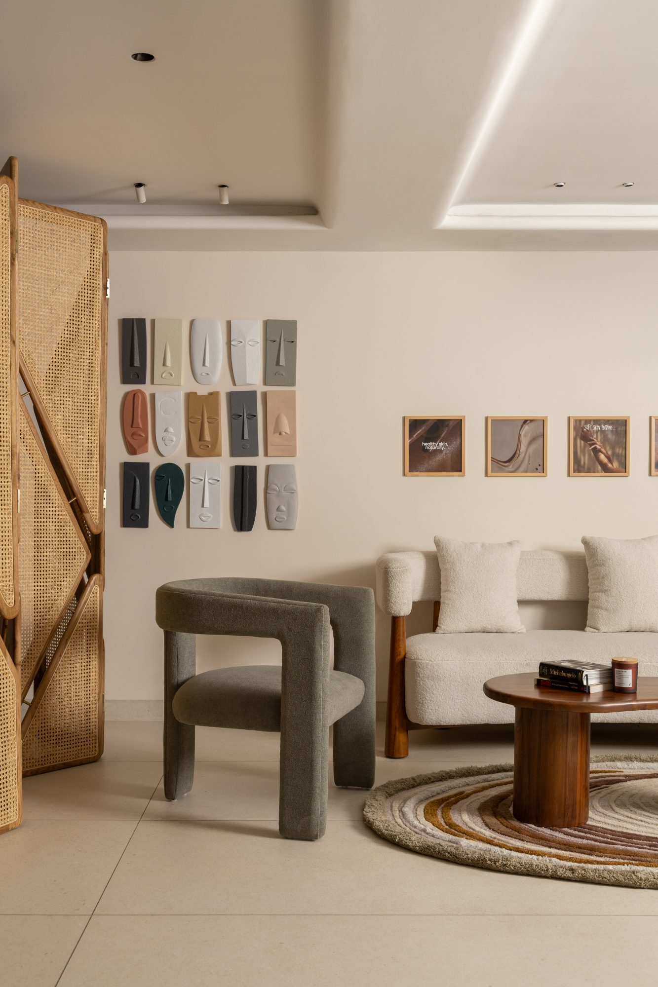 Lounge screened by a woven cane partition with an art grid