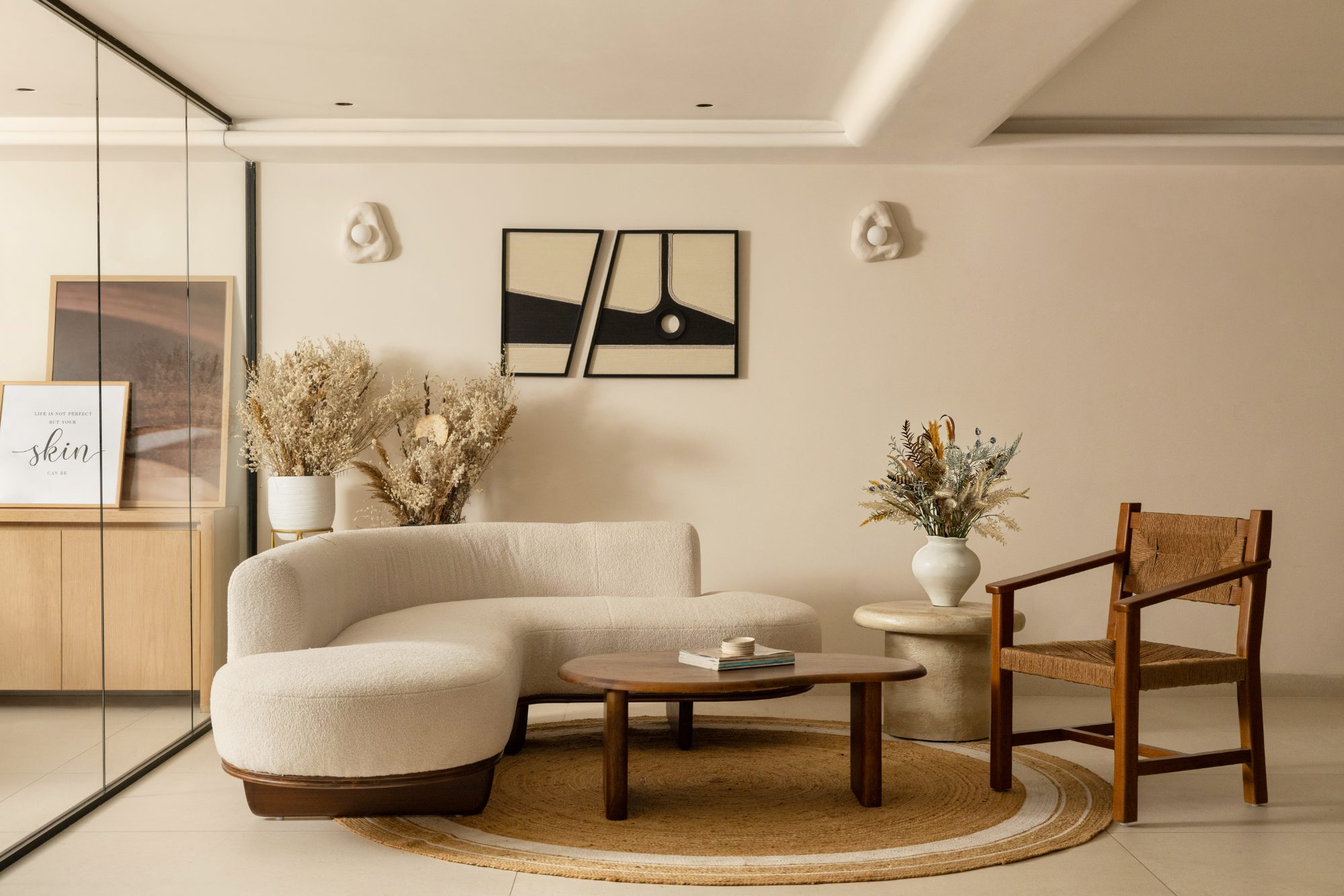 Kiara waiting lounge with a curved bouclé sofa and cane chair