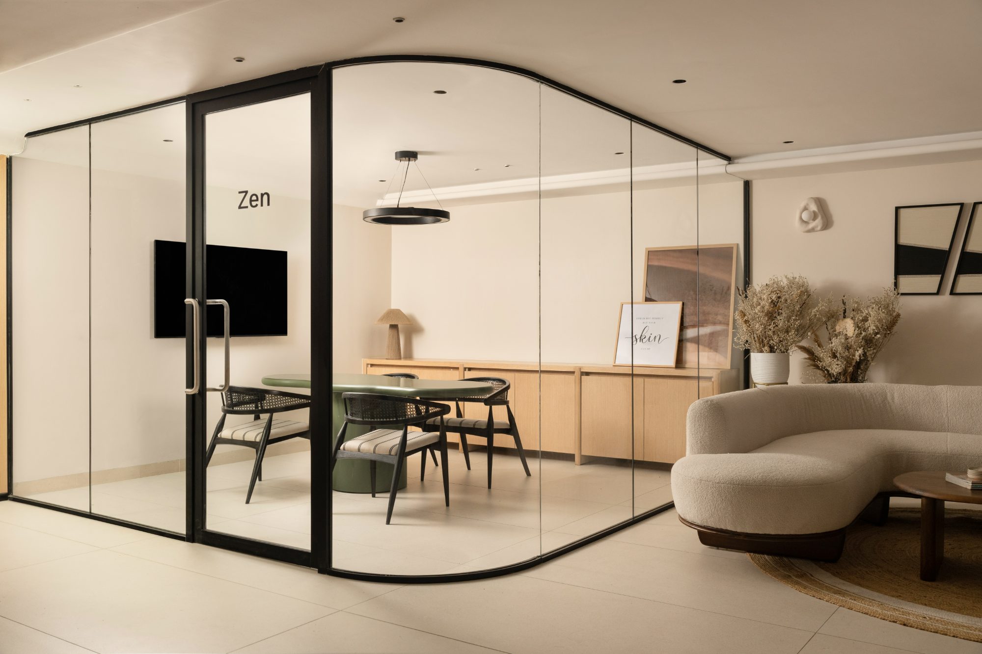 Glass-walled consultation room with curved black framing