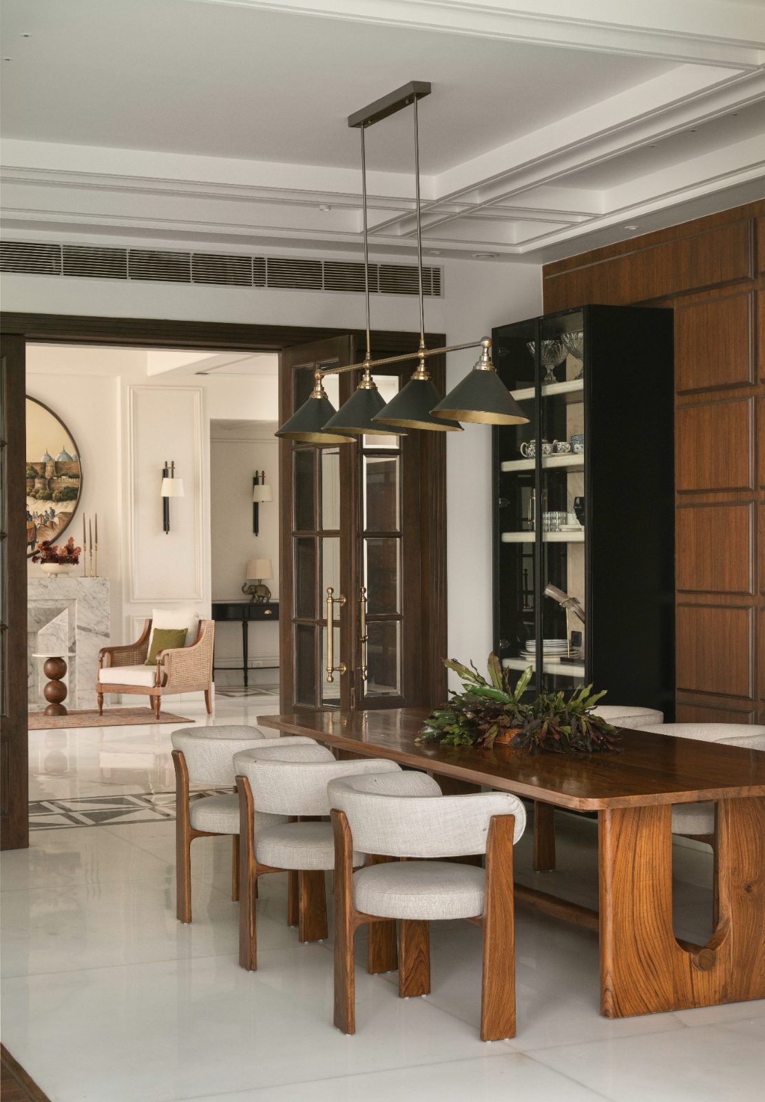 Dining room with brass pendants and a view through to the sitting room