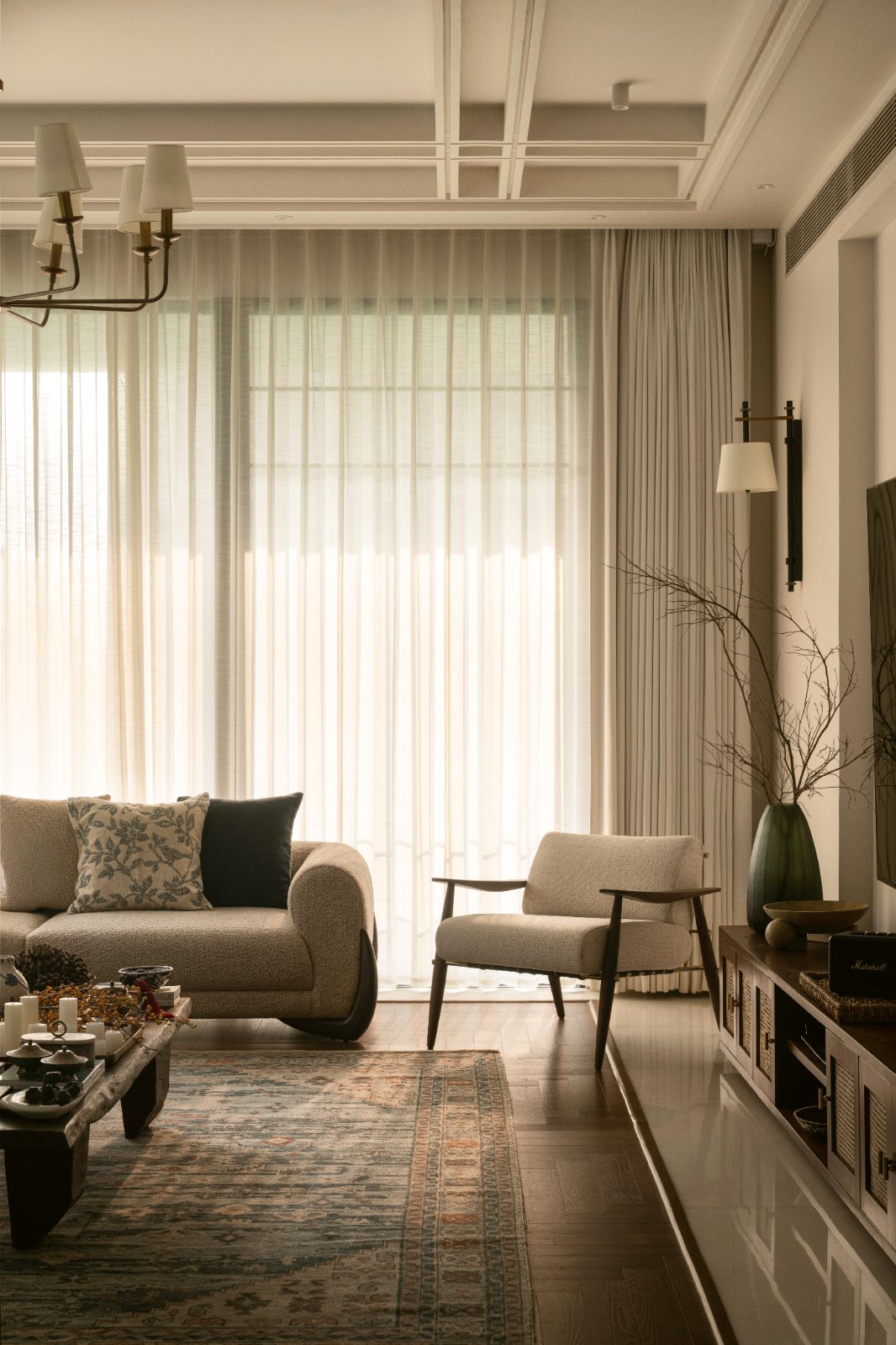 Living room bathed in warm light through sheer curtains