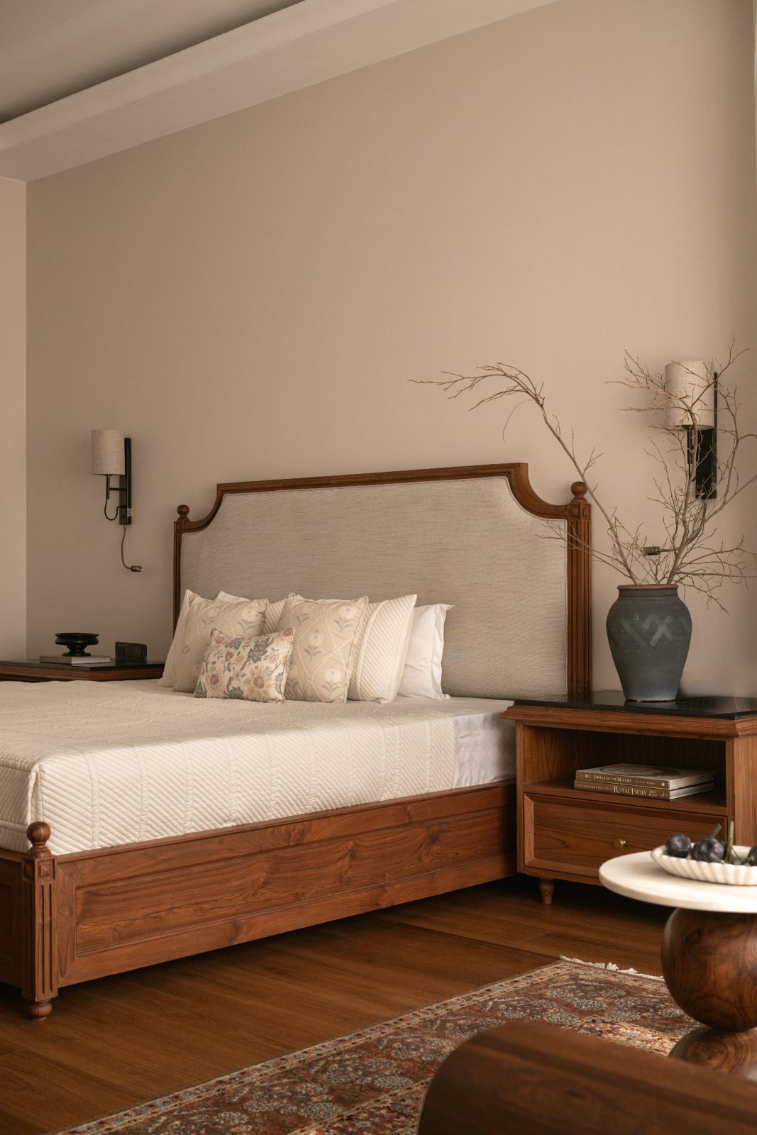 Bedroom with a fluted teak bed and upholstered headboard