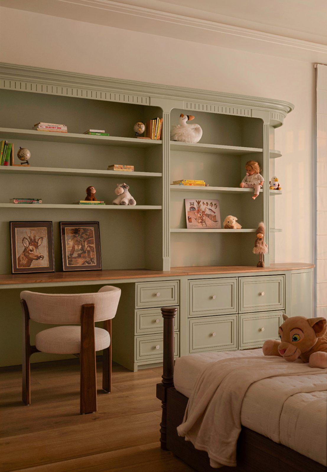 Children's room with sage-green built-in shelves and desk