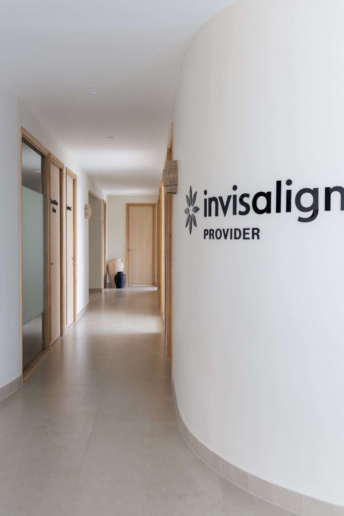 Oak-lined treatment corridor with consultation rooms