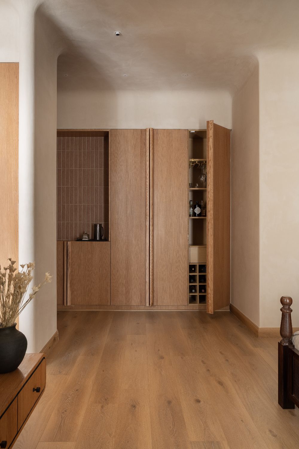 Concealed bar behind oak doors with wine storage
