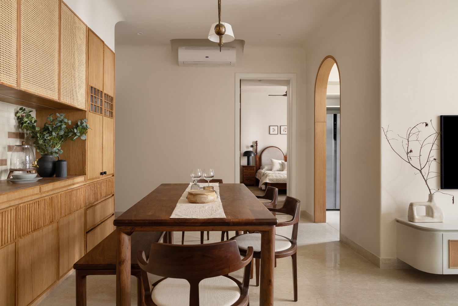 Samsara Avasa — warm-minimalist dining room with cane joinery