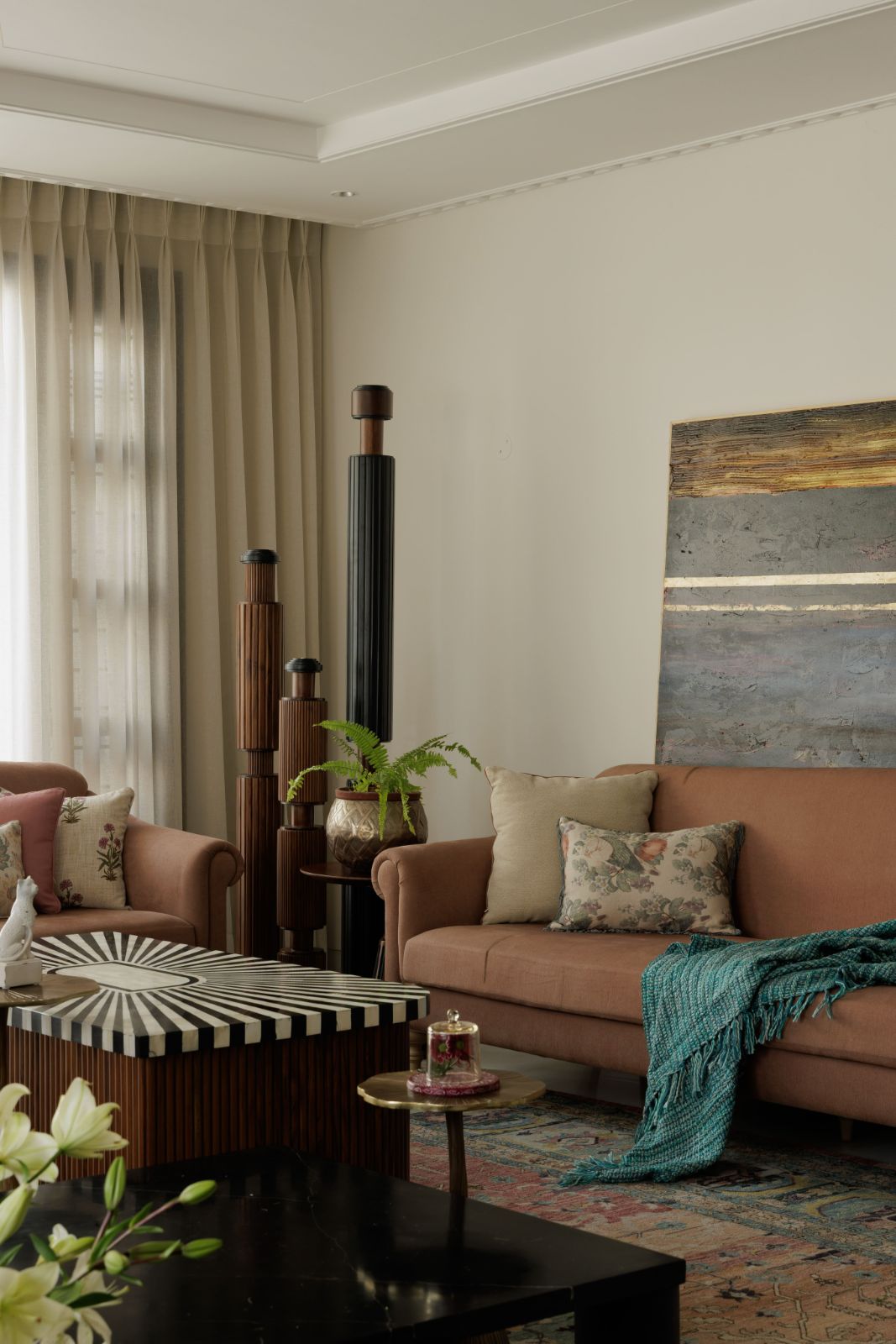 Family living room with brown sofa, abstract art and sculptural columns