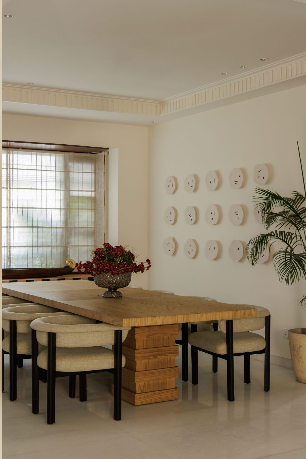 Dining room with live-edge table and ceramic disc art wall